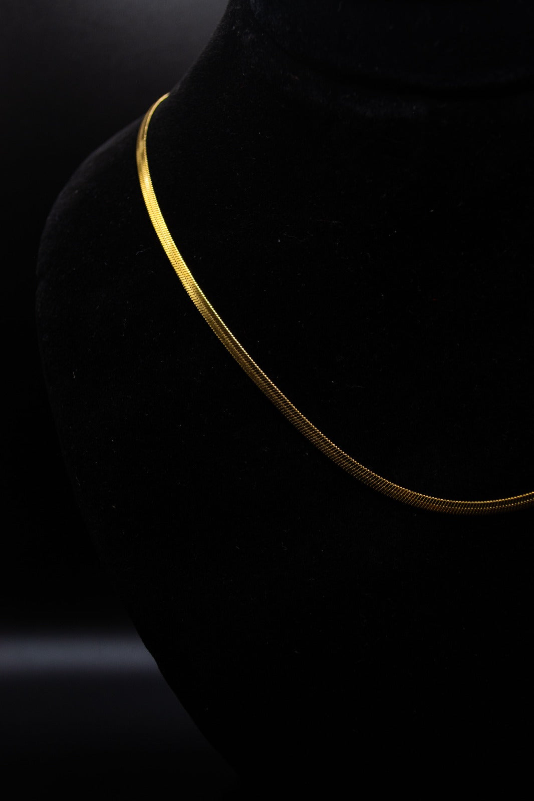 "Gold necklace on a black background"